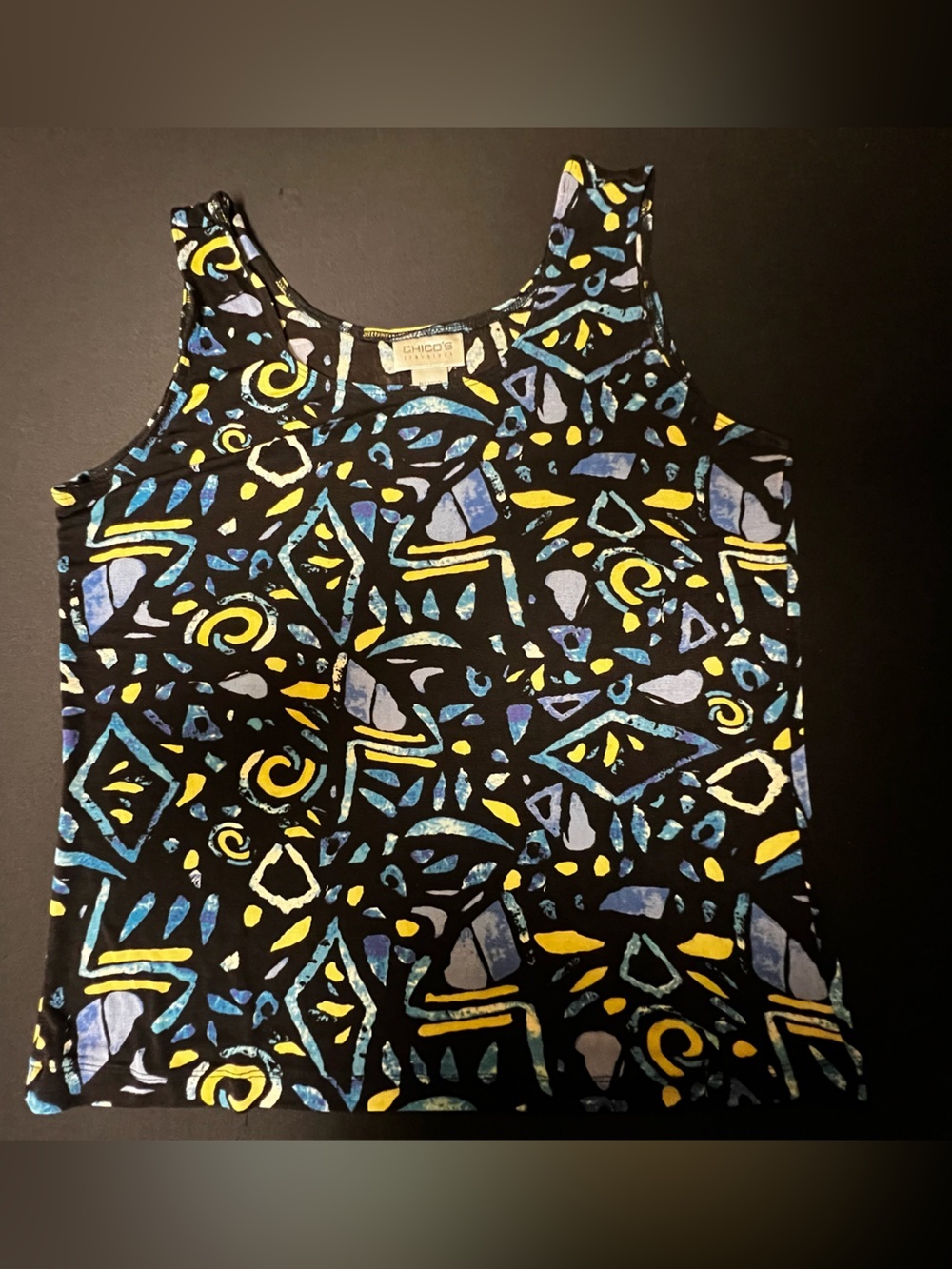 CHICO’S TRAVELERS BLACK TANK W/BLUE  & YELLOW ABSTRACT MOTIF.  SIZE 2.